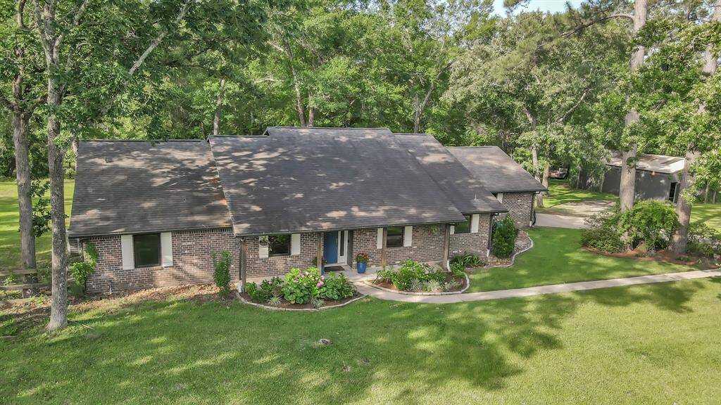 Country living in the trees with Highway 249 less than three miles away.