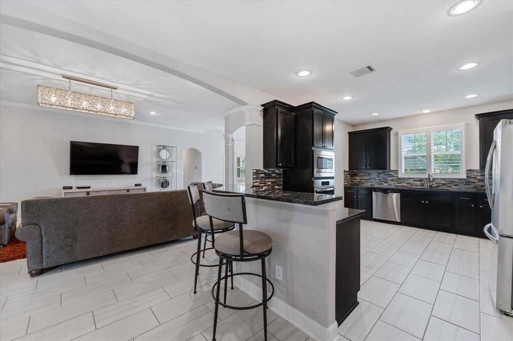 The kitchen opens up to both the living room and the dining room.