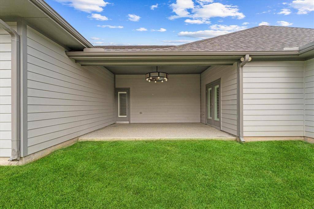 Covered back patio with doors to the breakfast nook and media room.