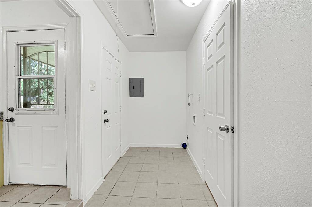 The utility room is conveniently located inside the home.