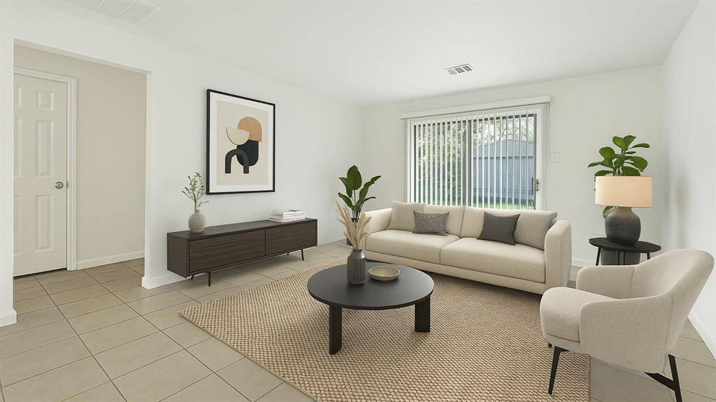 The living area features a bright and modern area with large windows and neutral tones. The sloding glass doors offer an abundance of natural light. ***Virtually Staged***