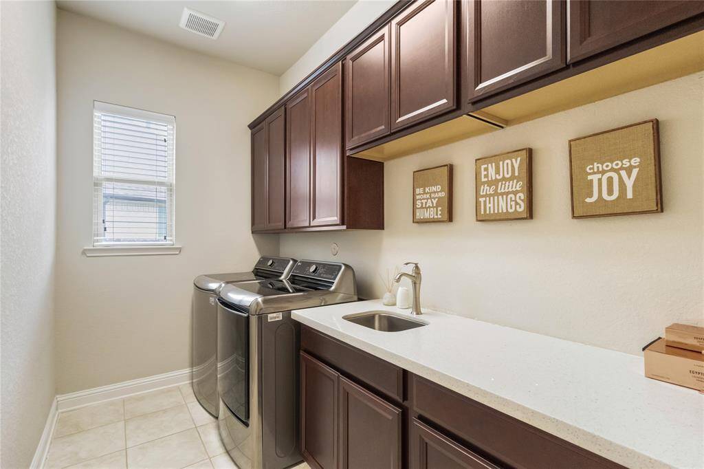 Spacious laundry room with ample storage.