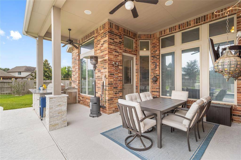 Enjoy this covered outdoor patio complete with a ceiling fan, built in speakers and mounted tv!