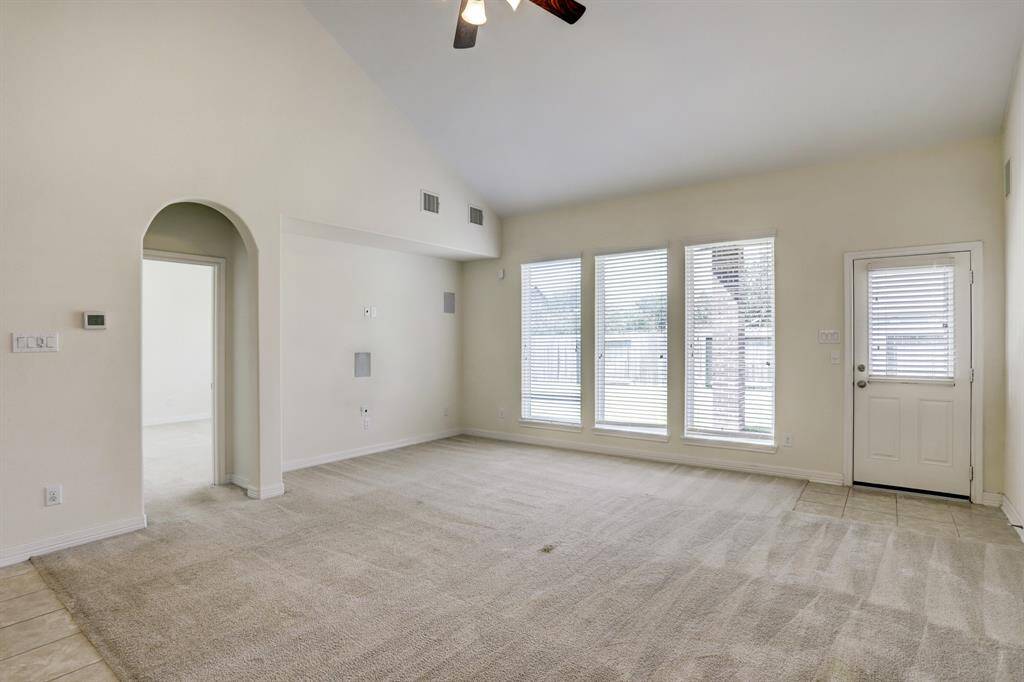 Sunlit and spacious— this living room offers effortless flow into the primary bedroom and backyard, making everyday living feel seamless.