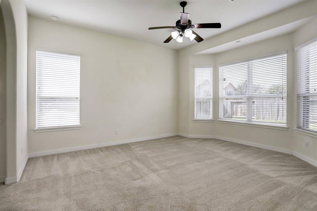 Welcome to the primary bedroom— comfortable, light-filled, and ready for your personal touch.