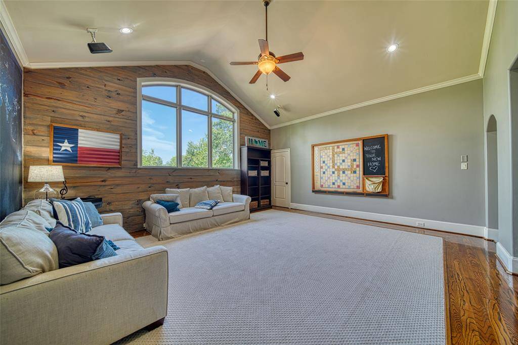 Second Floor Game Room with accent wall and Custom Built In Entertainment Center