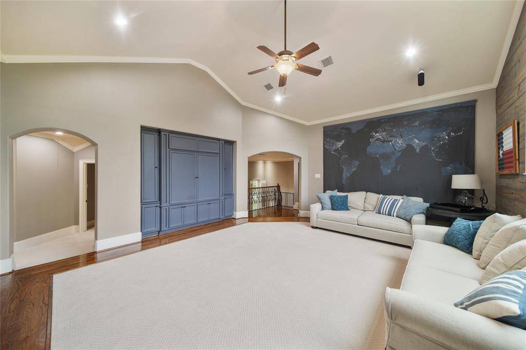 Multi Level Media Room, complete with chairs, screen, speakers and all media equipment.