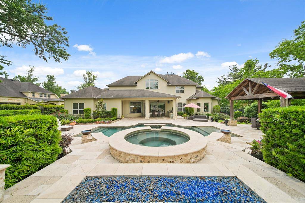 Extended Covered Patio, Summer Kitchen with Grill, Beverage Fridge, Sink, Tons of lighting and ceiling fans.