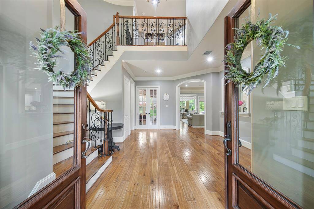 Beautiful Double Doors, Wood Flooring and Wrought Iron Railings!