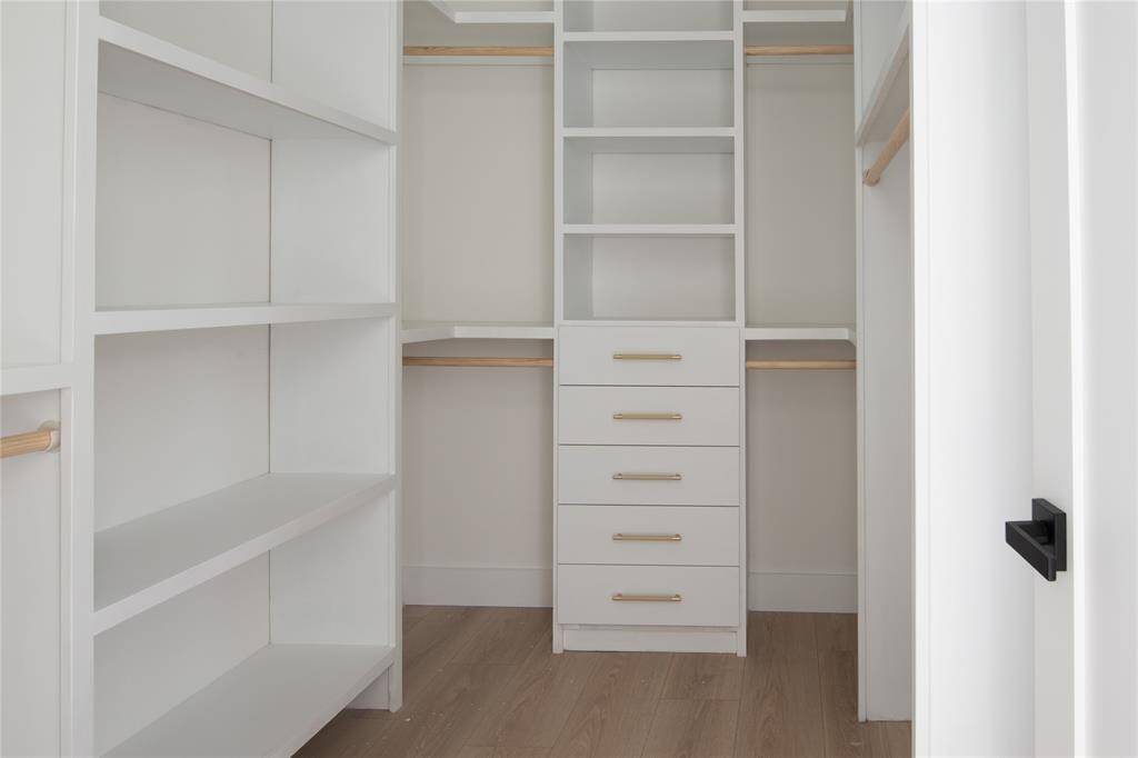 Walk-in closet with plenty of storage.