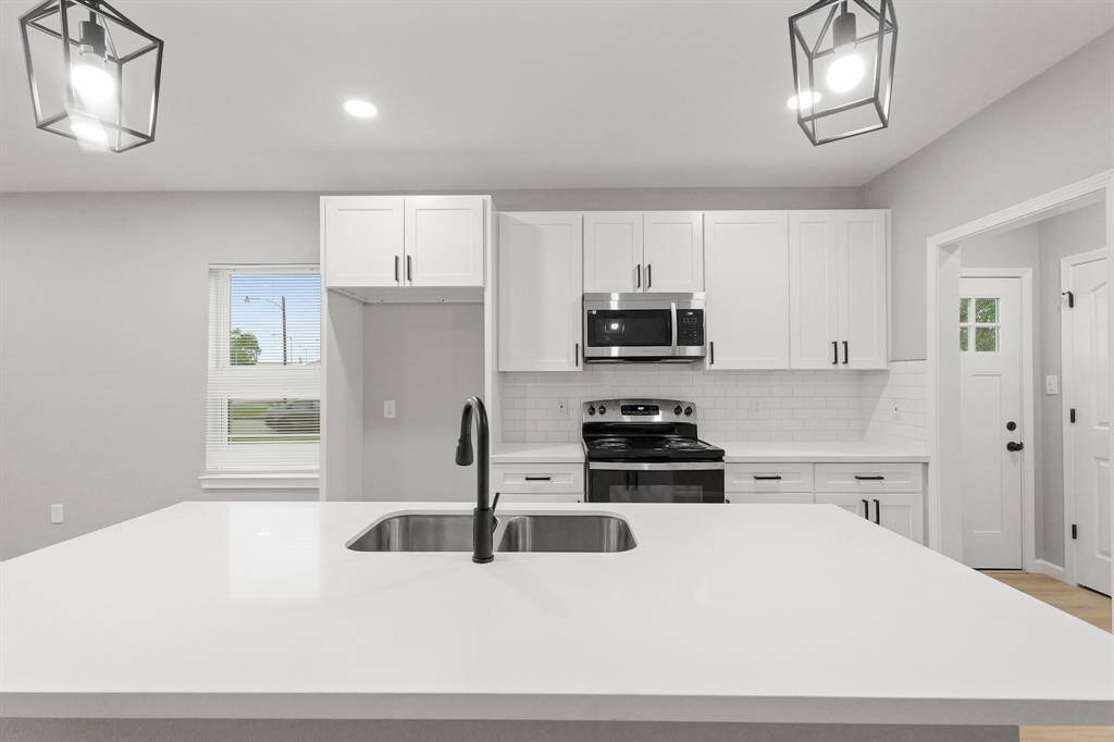 Granite countertops paired with a coordinating stone backsplash not only provide a durable and elegant surface for food preparation but also add a touch of luxury and sophistication to the kitchen.