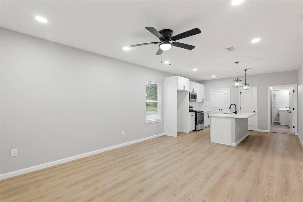 Durable and stylish vinyl plank flooring welcomes you into the open-concept living and kitchen area, combining comfort with modern appeal.