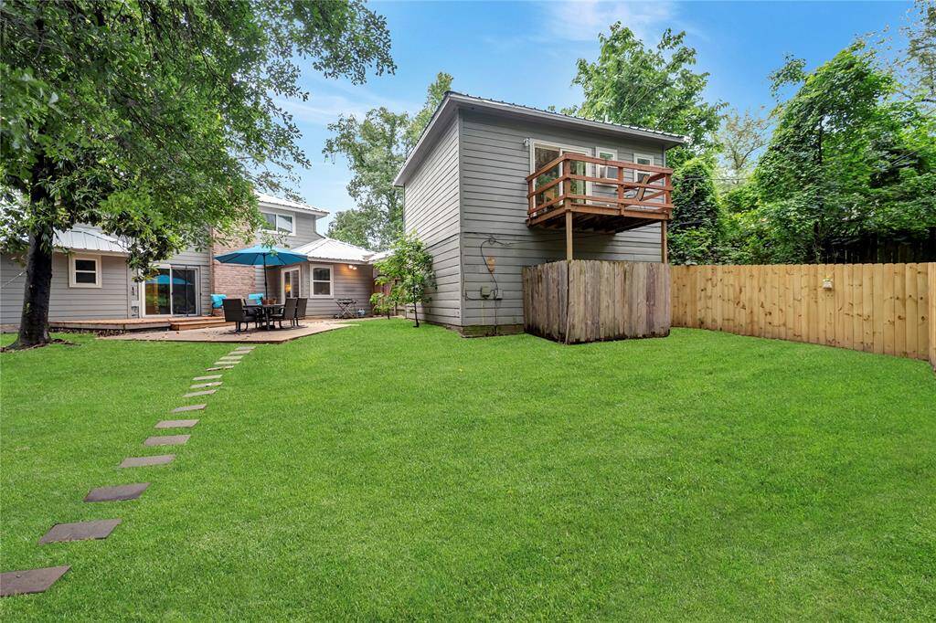 Backyard with view of garage apartment guest suite and balcony