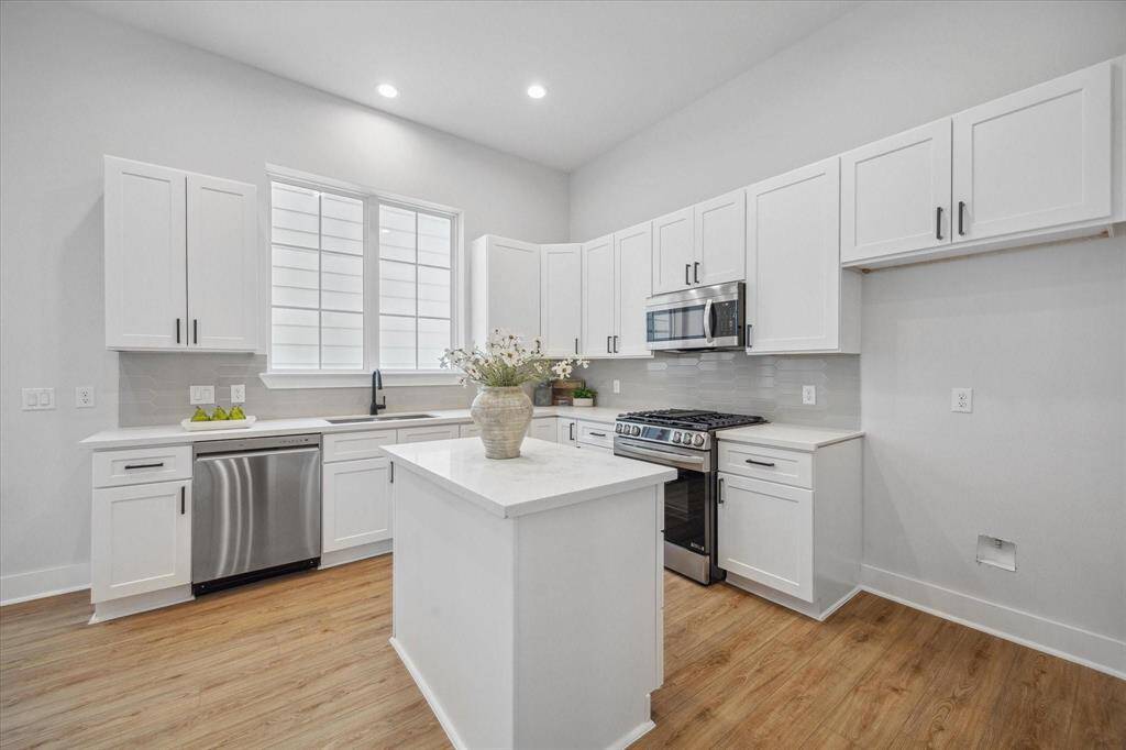 This kitchen is equipped with a gas range and features anisland for food preparation, dining, and entertaining. Soft closing cabinets and drawers.