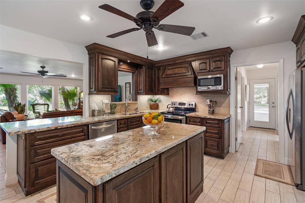 Gourmet kitchen with granite countertops, stainless steel appliances