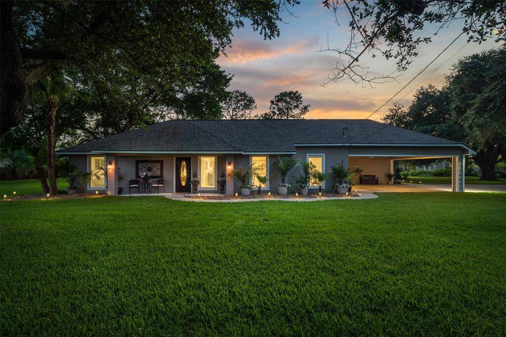 Welcome home to this pristine 4/4.1/2 car carport home on 1.11 acre in the heart of League City!