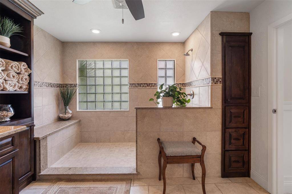 Texas sized shower! Fully tiled, bench seating.