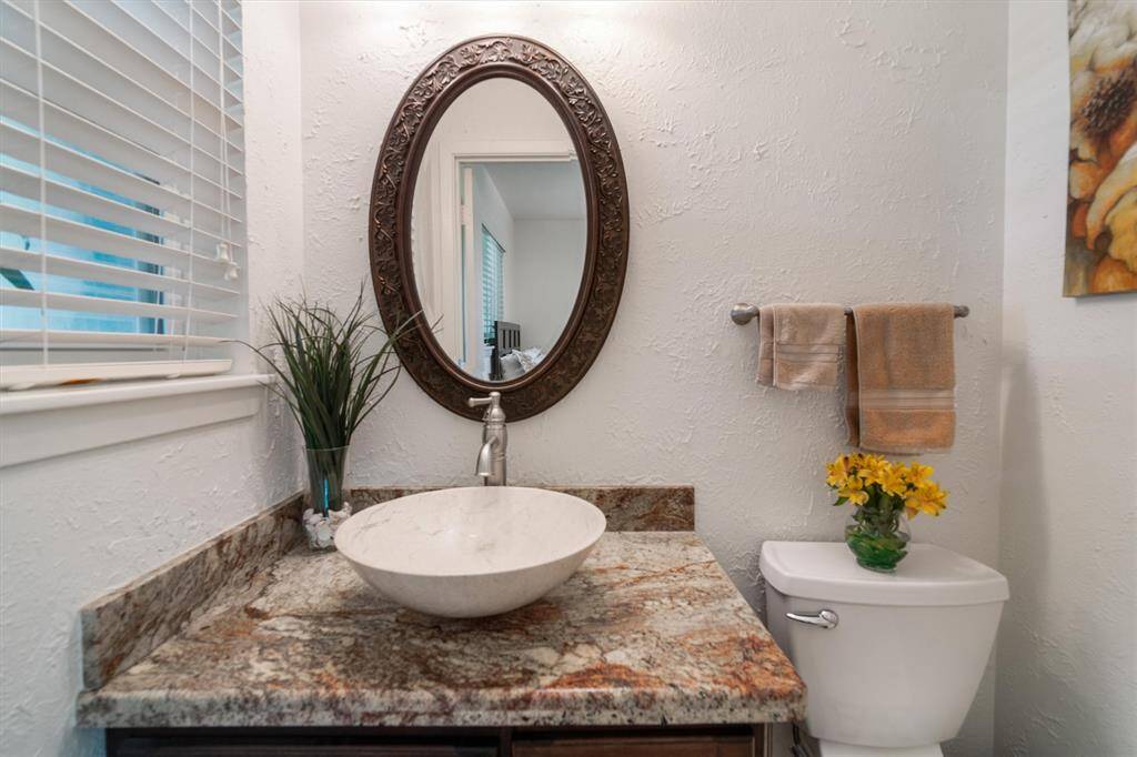 Half bath with designer vanity and framed mirror