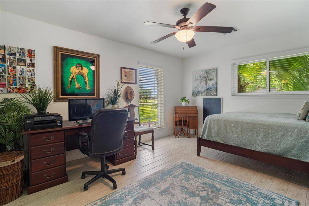Fourth bedroom, windows letting in natural light, tile flooring