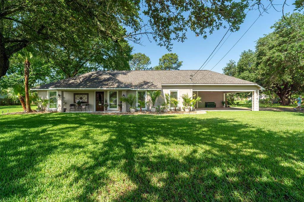 Welcome home to this pristine 4/4.1/2 car carport home on 1.11 acre in the heart of League City!