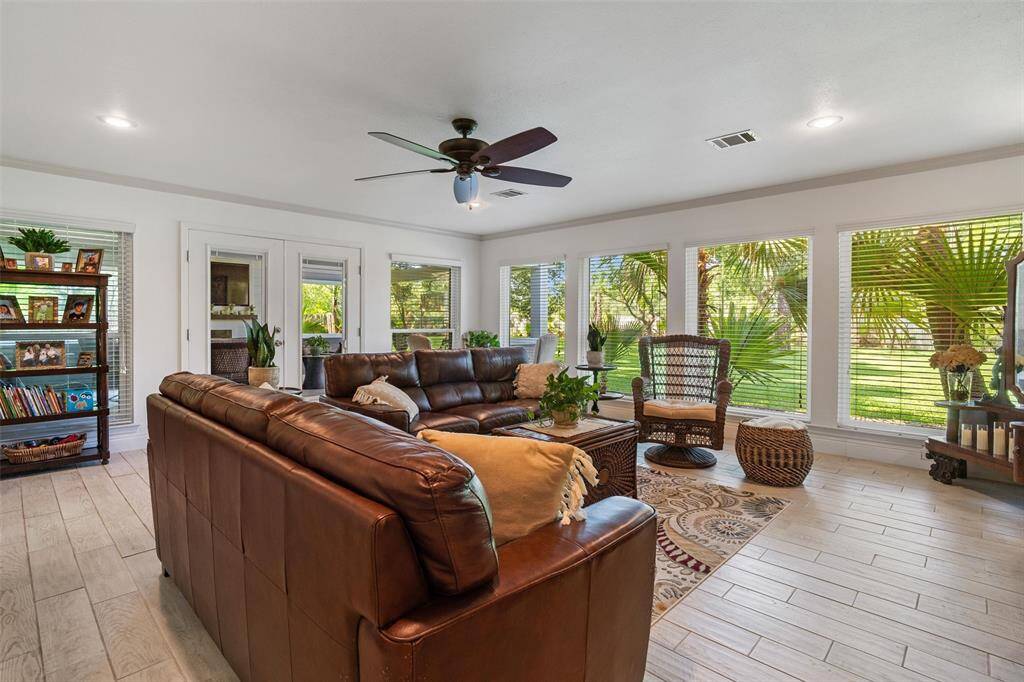 Beautiful living room! Floor to ceiling wall of windows overlooking your quiet and tranquil property. Tile flooring throughout.