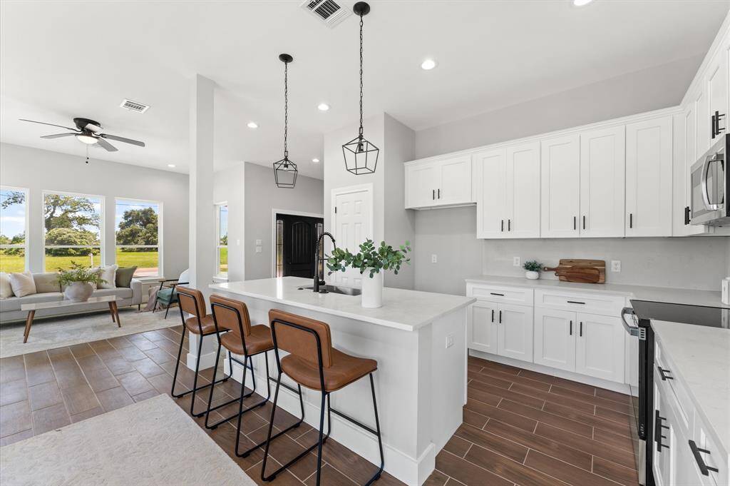 Modern kitchen with center island, open to the dining and living room.