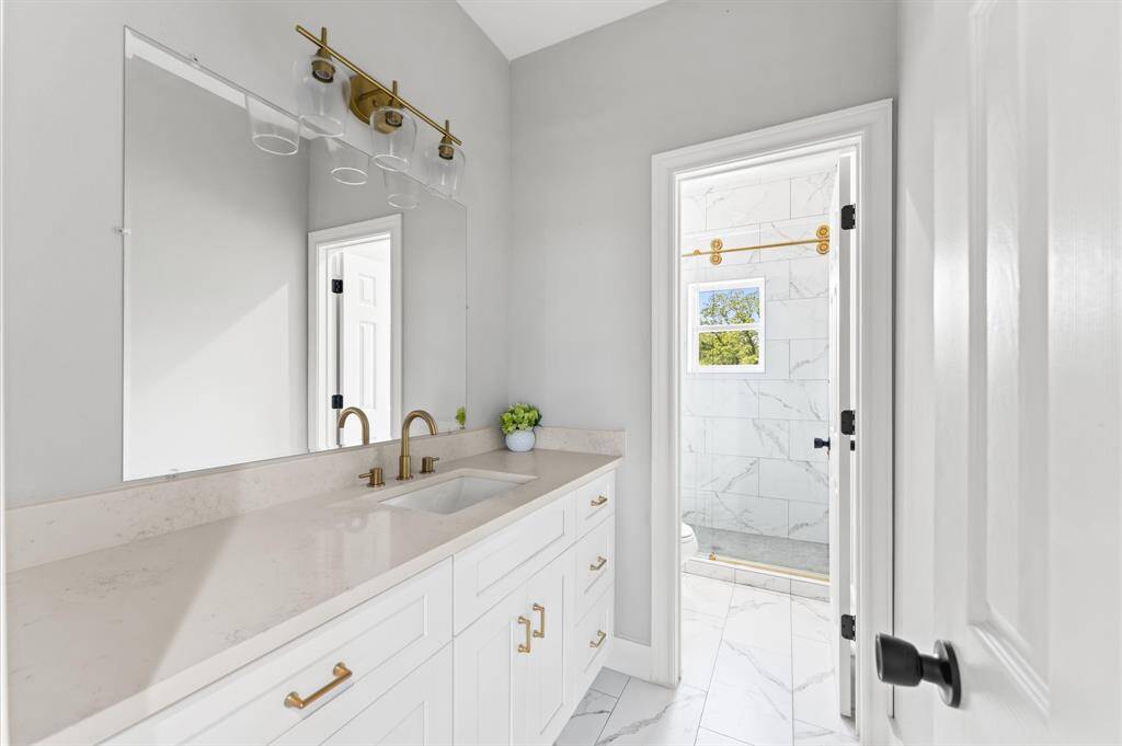 Full bathroom with modern fixtures and tile in shower.