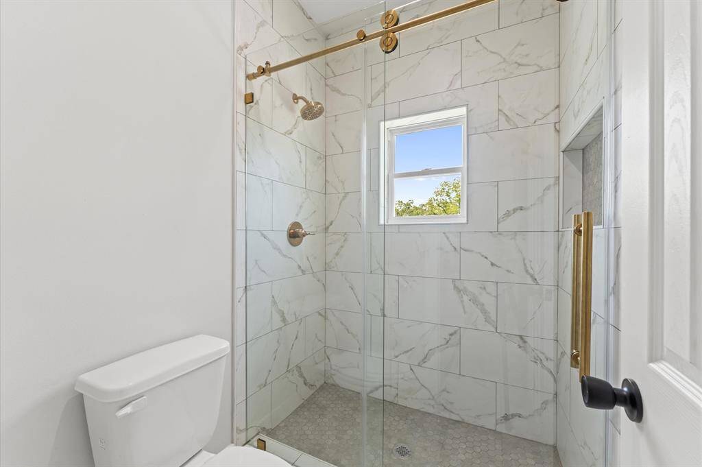 Full bathroom with modern fixtures and tile in shower.