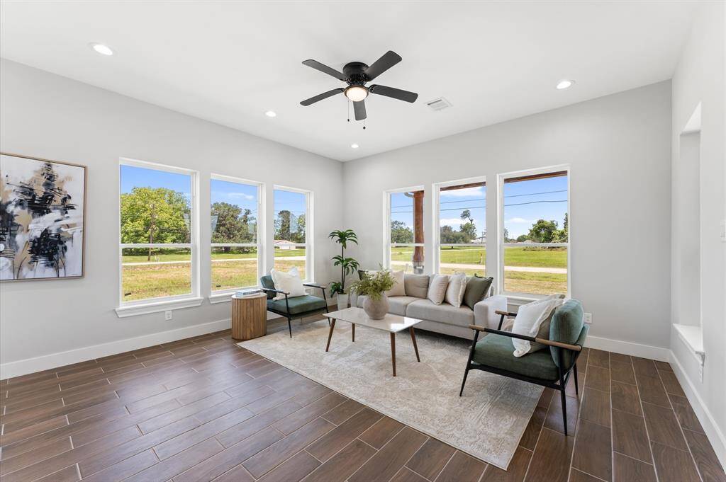 Airy open living room with large windows.