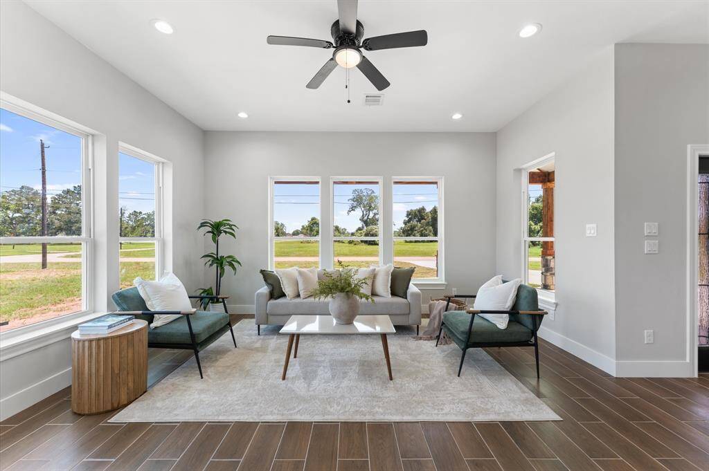 Airy open living room with large windows.