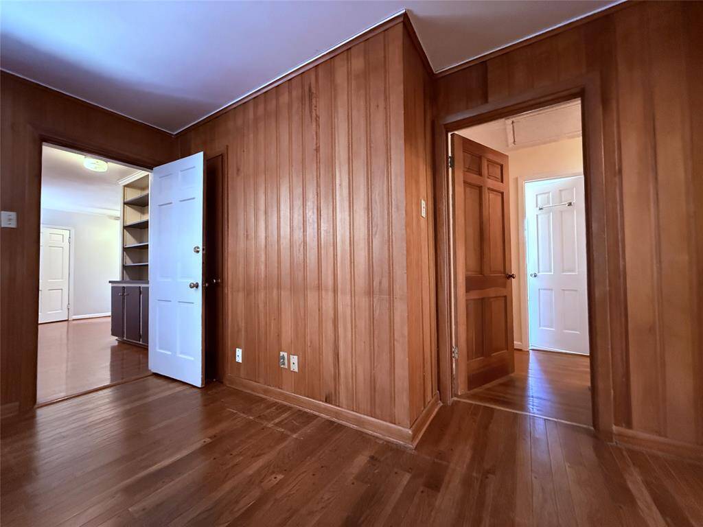 From the family room, a door opens into the hallway leading to the guest bath & the other two bedrooms.