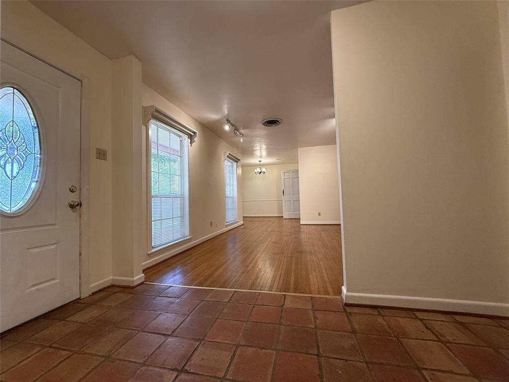 From the entry, natural light flows into the living room from twin windows.