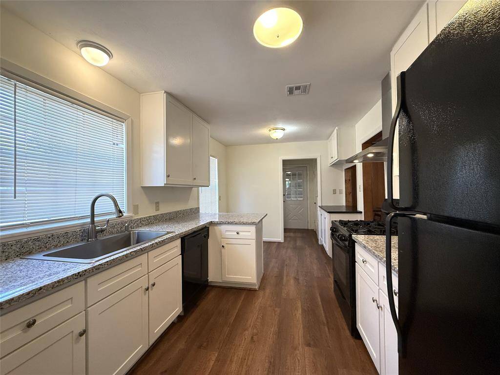 Past a swinging door from the dining room is the updated kitchen.