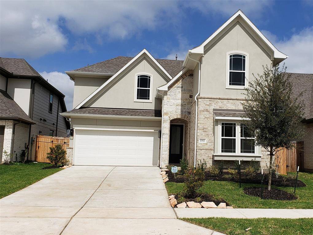 The Mediterranean-inspired stucco exterior lends this home a timeless elegance, creating a warm and inviting first impression.
