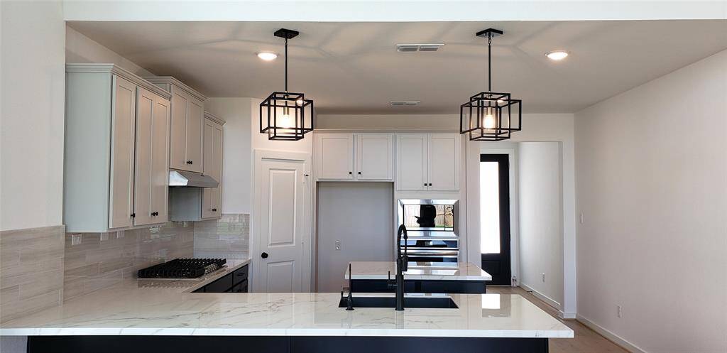 Spacious and open, the great expansive room seamlessly flows into the kitchen, creating the perfect setting for both everyday living and effortless entertaining.