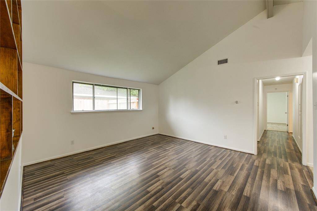 Large window and high ceiling adds to this room’s appeal.