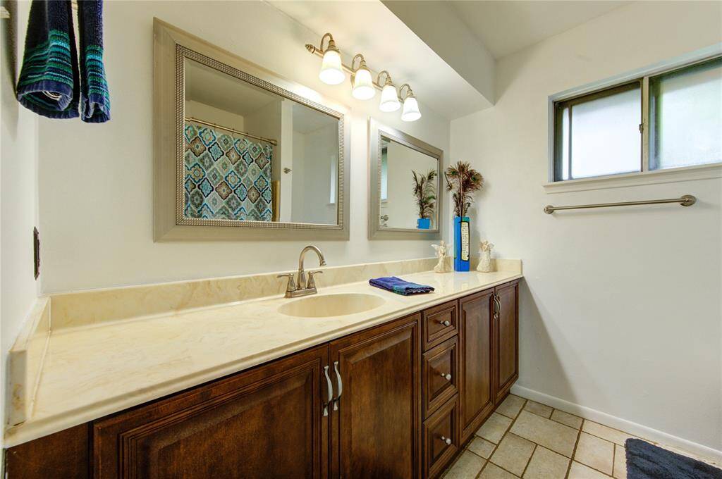 Hall bath has tons of storage.