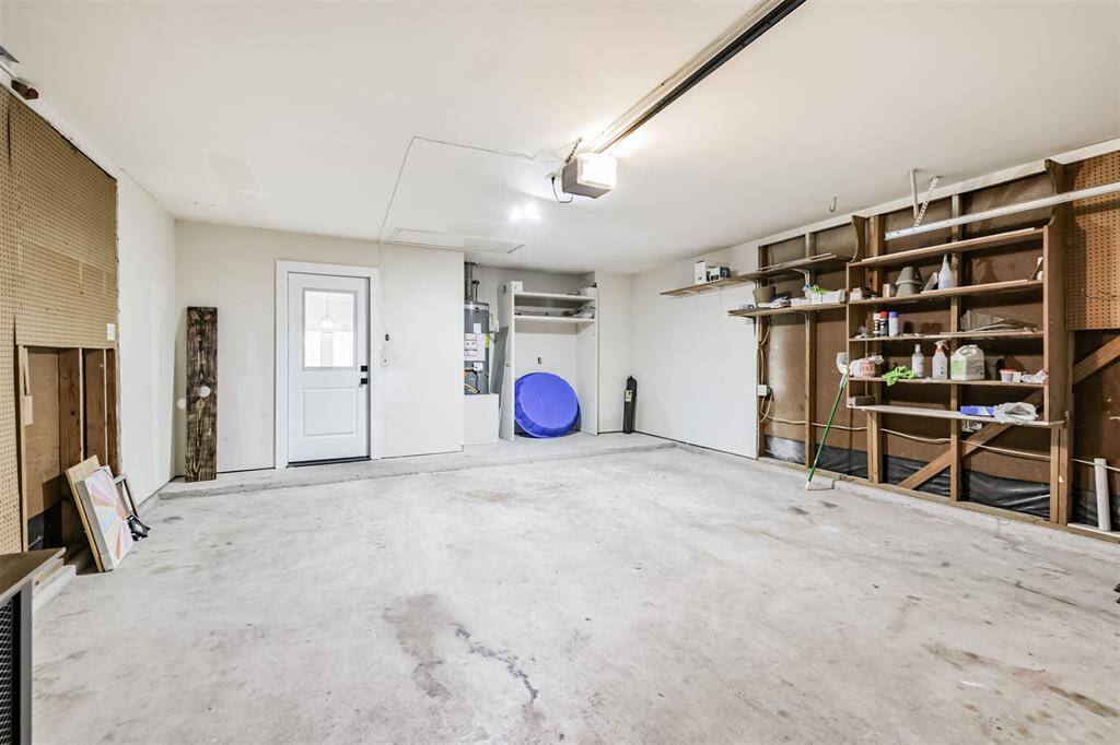 Garage includes Automatic Garage Door Opener and shelving!