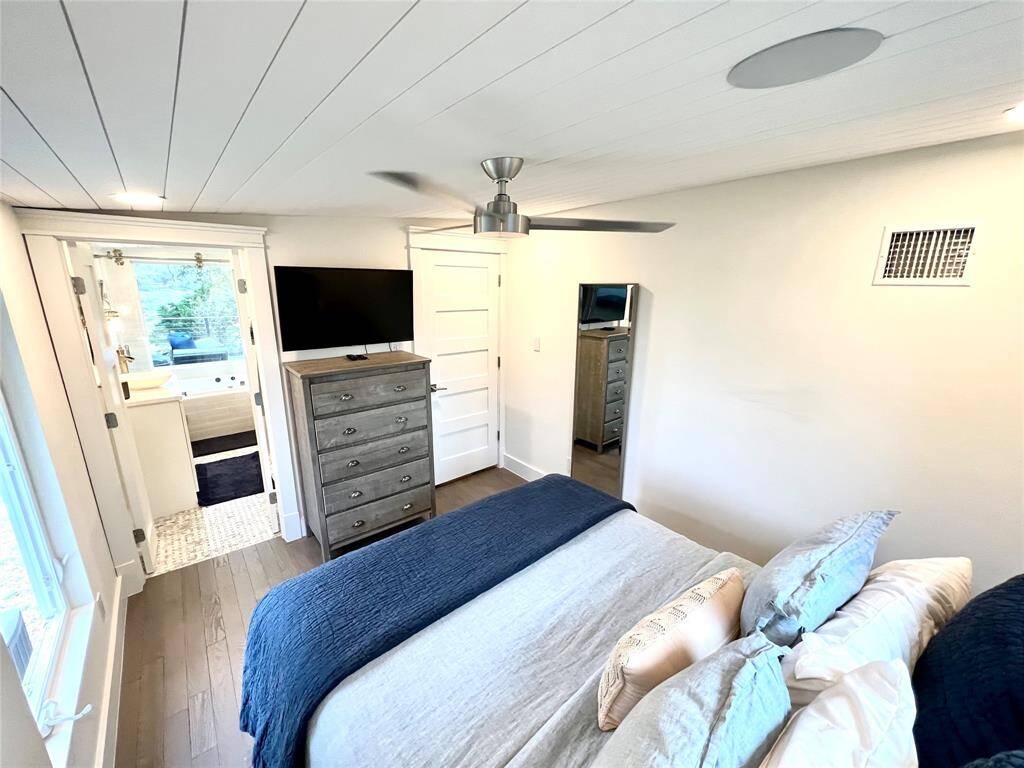 Indulge in serene lake views from the comfort of your luxurious primary bath/shower combo.