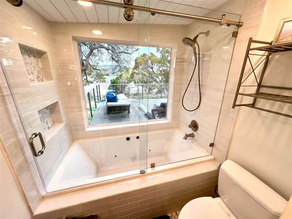 Cozy secondary bedroom with stylish bunk beds, abundant natural light, and a sleek ceiling fan. Perfect for guests or children.