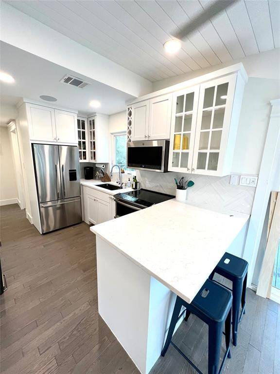 It opens up to a deck through sliding glass doors, offering scenic views.