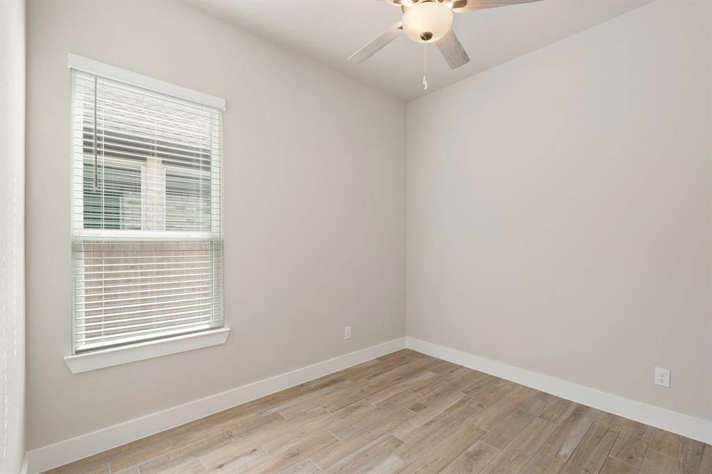 Bright and welcoming, this bedroom features a large window and neutral tones to easily complement any décor style.