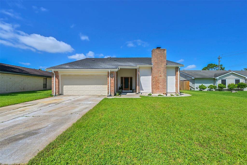 Charming single-story home with a spacious front yard, attached two-car garage, and a welcoming brick exterior. Features a prominent chimney and a clean, well-maintained driveway. Ideal for those seeking a cozy suburban residence.