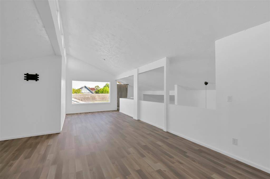Spacious, bright room with high ceilings and large window offering natural light.