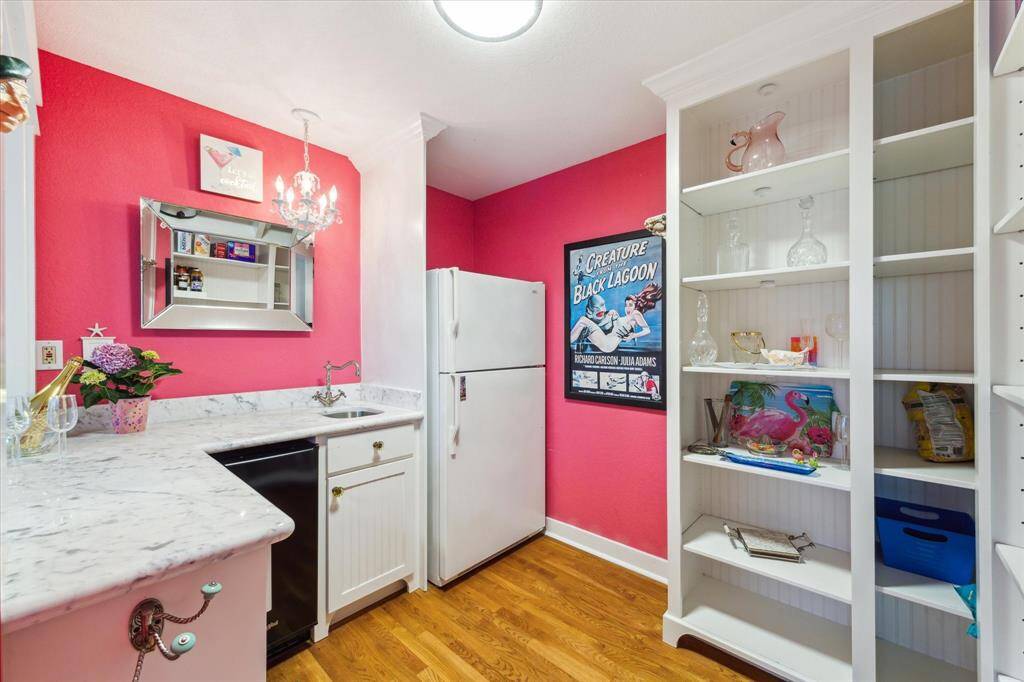 bar has abundance of cabinet space, ice maker, seperate refrigerator from the kitchen