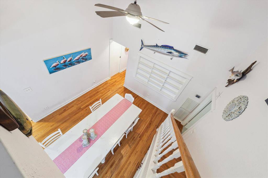 Dining Room illustrates high ceilings, wood flooring and multiple cabinet area for decor displays