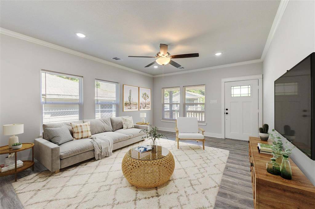 Bright and inviting living room with large windows and modern finishes. Virtually staged to showcase the potential of this beautiful space.