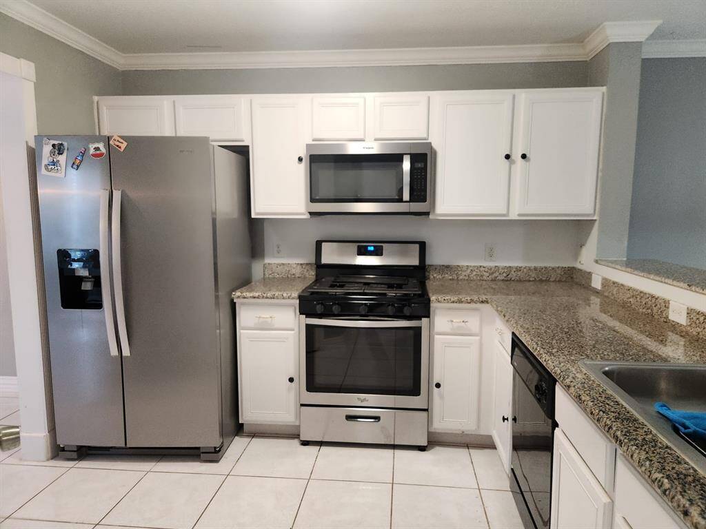 Kitchen view with stainless steel appliances (micro, range/oven, and fridge)
