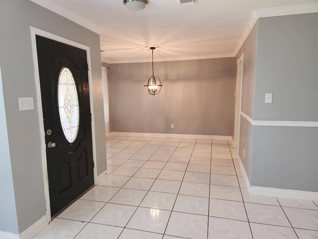 Entry door with view of dining area