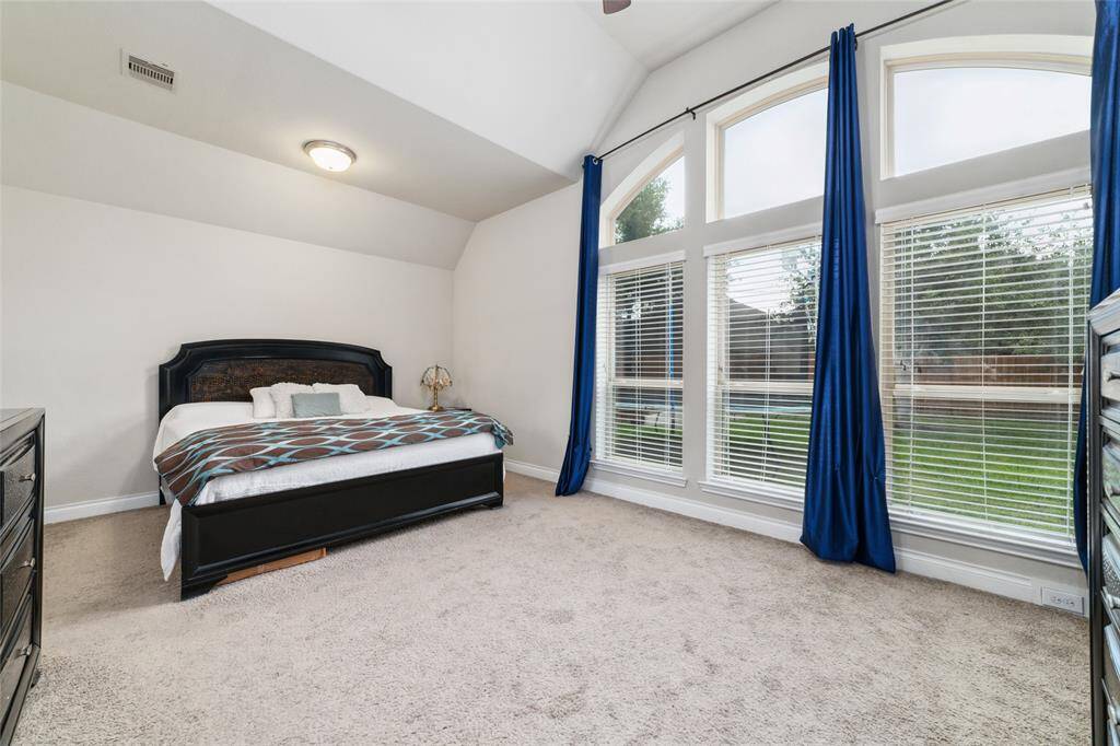 Spacious primary bedroom featuring oversized recessed windows that fill the room with natural light, easily accommodating a king-sized bed with room to spare.